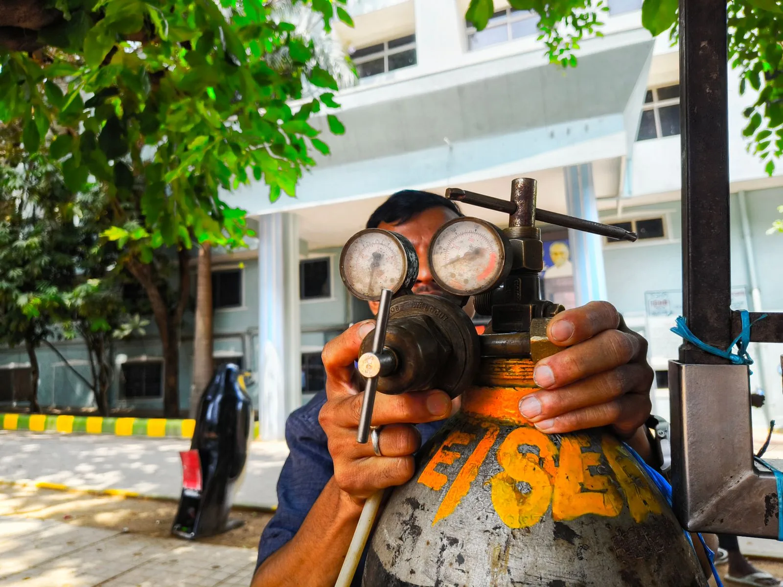 Technician checking a gas line regulator with pressure gauges during gas line inspection service in a Miami home