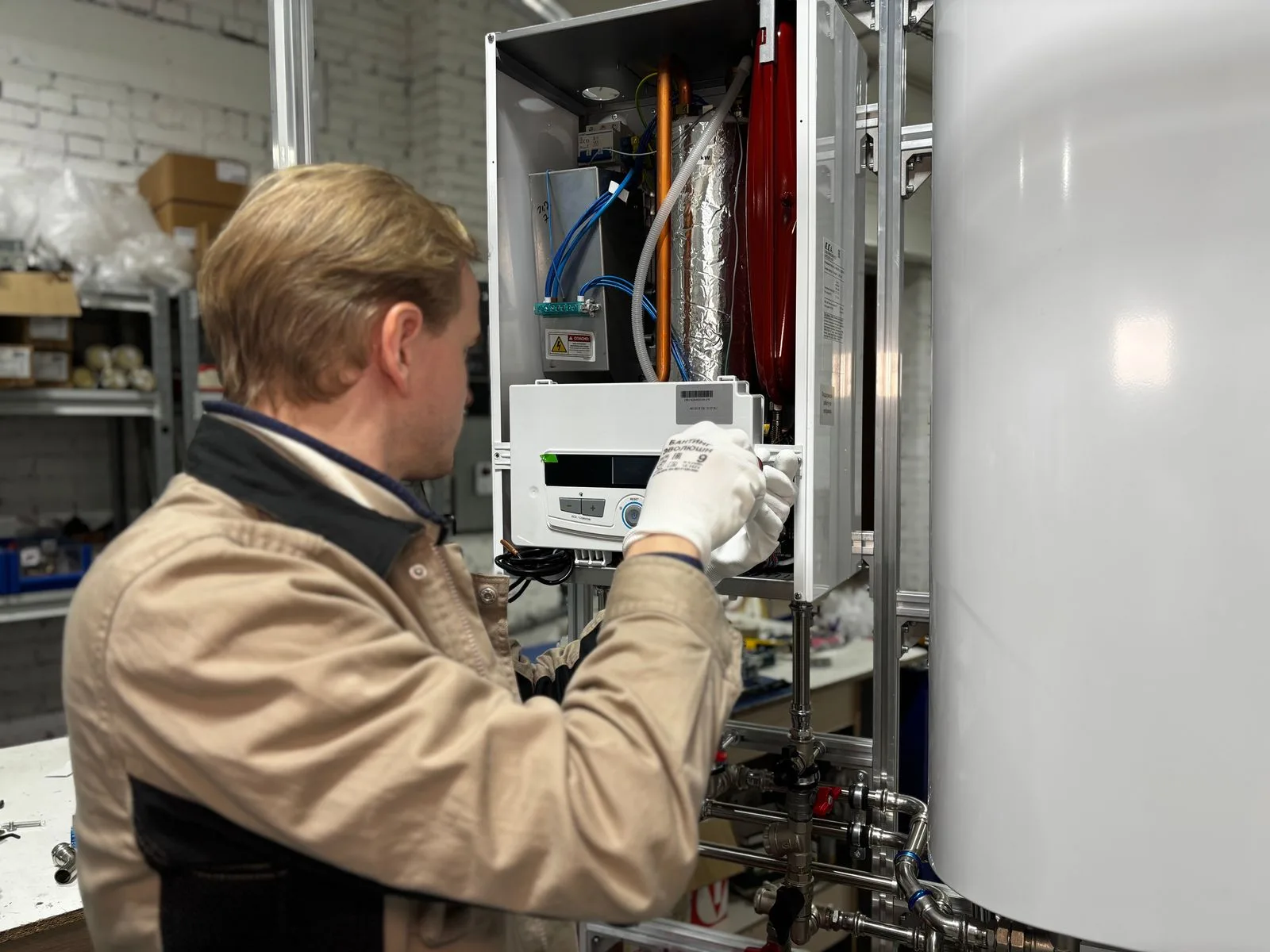 Technician in gloves servicing an open wall-mounted water heater during a water heater repair visit in a Miami home